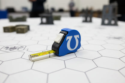 Ultramarines Space Marine tape measure extended showing dual scale - Warhammer 40K 10ft measuring tool with chapter emblem